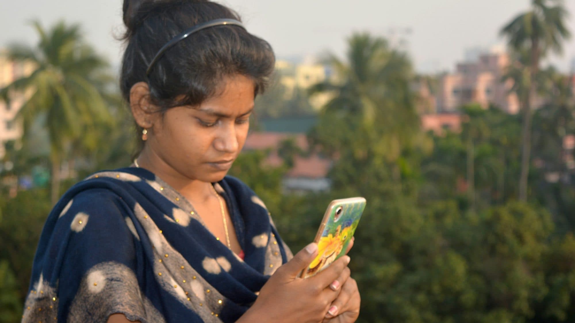 A young woman checking her phone outdoors